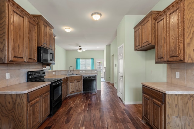 kitchen with dark hardwood / wood-style flooring, black appliances, ceiling fan, and backsplash