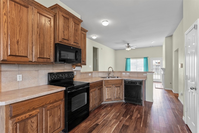 kitchen with black appliances, sink, backsplash, dark wood-type flooring, and ceiling fan