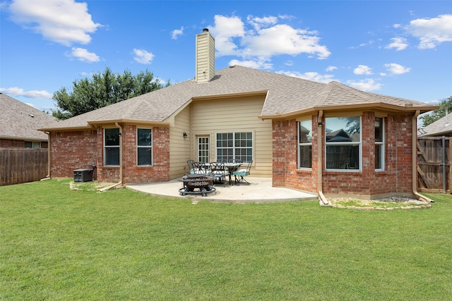 back of property with a patio and a yard