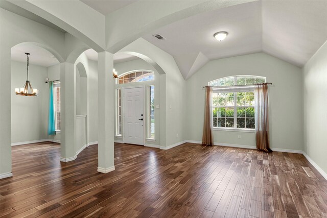 entrance foyer with an inviting chandelier, wood-type flooring, and lofted ceiling