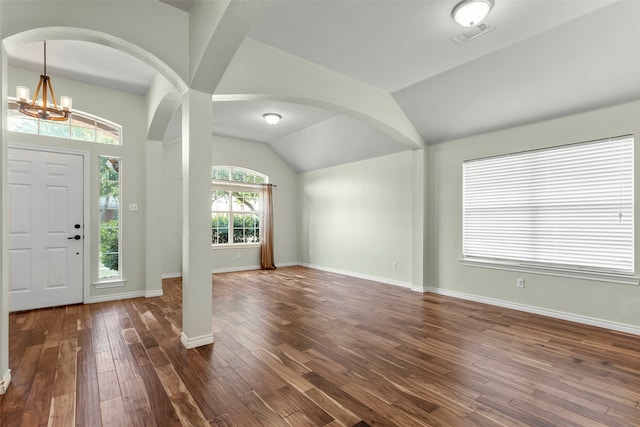 foyer entrance featuring lofted ceiling, a notable chandelier, and hardwood / wood-style floors