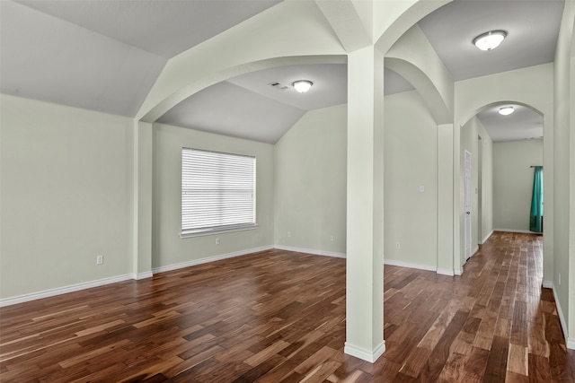 unfurnished room with wood-type flooring and vaulted ceiling