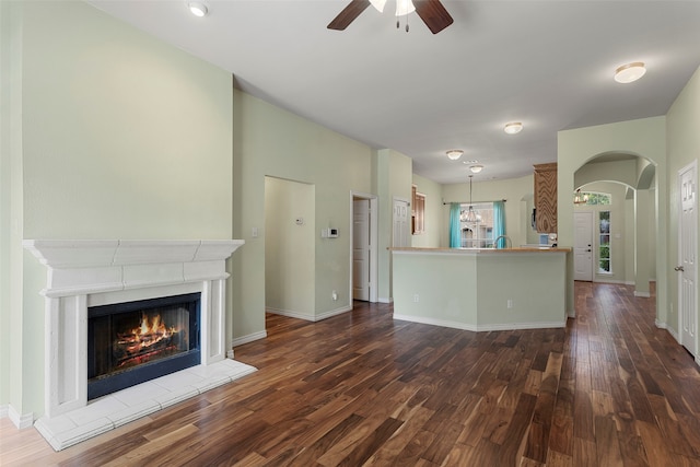 unfurnished living room with ceiling fan and hardwood / wood-style floors