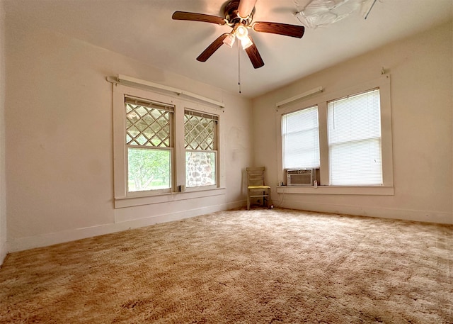 carpeted spare room featuring cooling unit, ceiling fan, and a healthy amount of sunlight