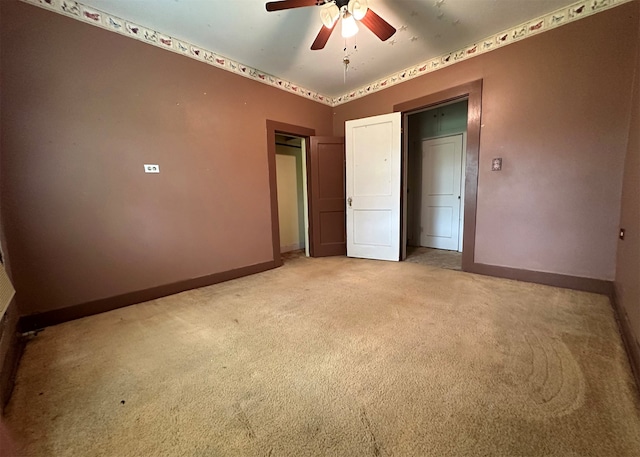 unfurnished bedroom with light colored carpet and ceiling fan