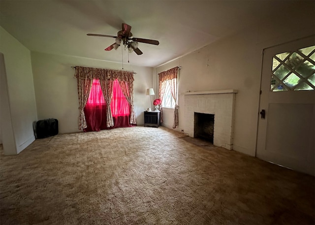 unfurnished living room with ceiling fan, carpet, and a brick fireplace