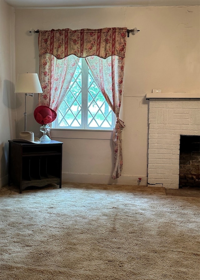 unfurnished living room with carpet floors and a fireplace