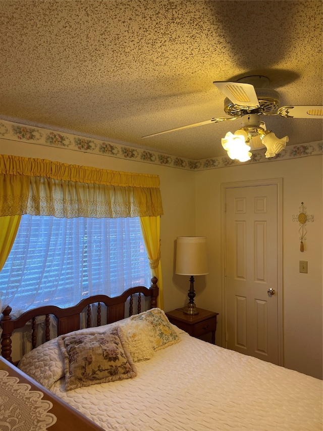 unfurnished bedroom with a textured ceiling and ceiling fan