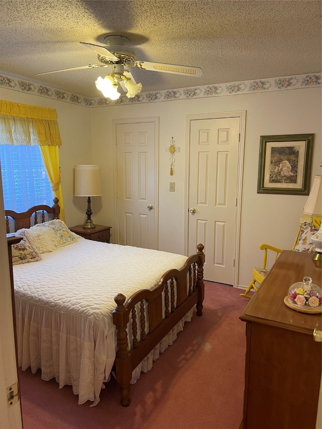 bedroom with carpet flooring, a textured ceiling, and ceiling fan