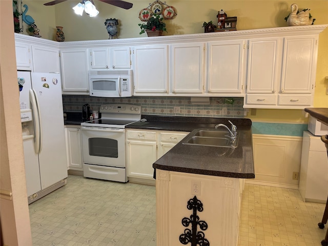 kitchen featuring white appliances, white cabinets, sink, decorative backsplash, and ceiling fan