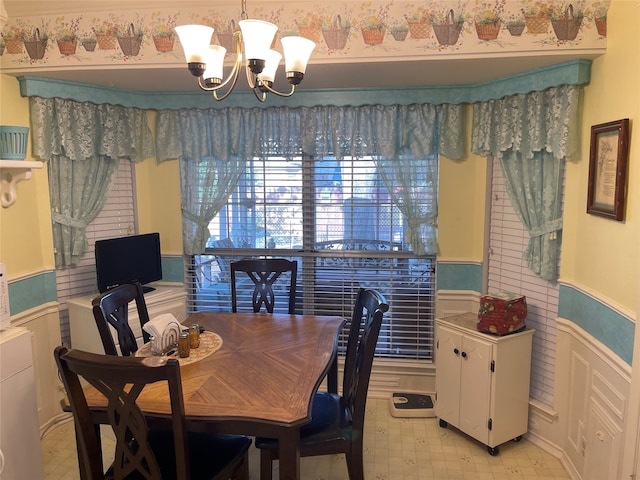 tiled dining area with a chandelier