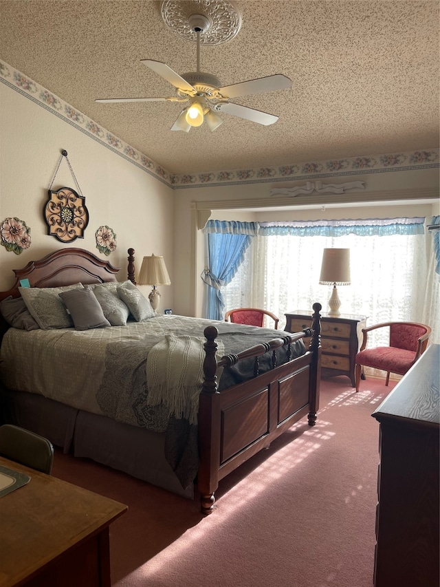 bedroom featuring carpet flooring, a textured ceiling, and ceiling fan