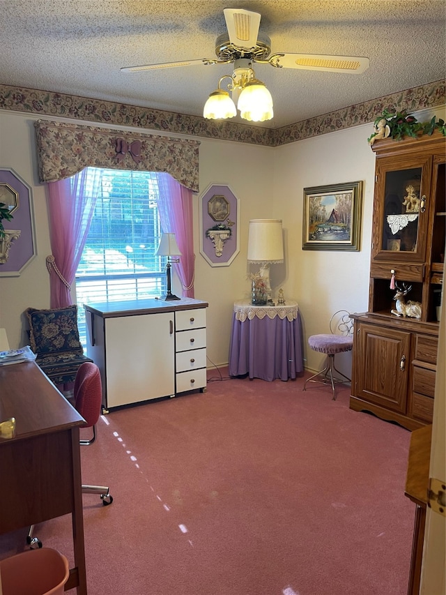 carpeted office space featuring a textured ceiling and ceiling fan