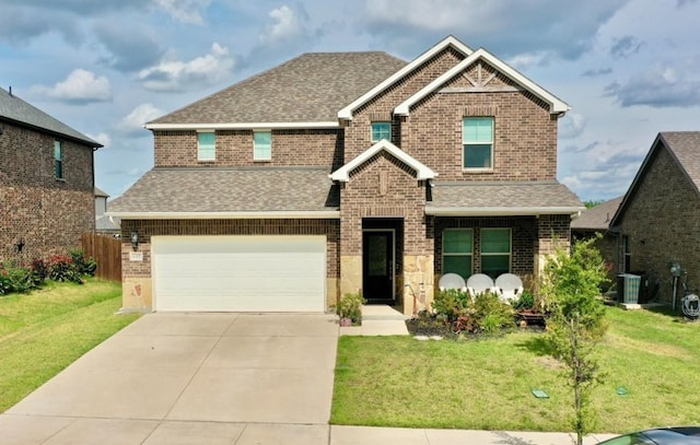 craftsman house with a garage and a front lawn