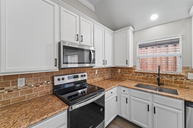 kitchen featuring sink, light stone counters, white cabinets, and appliances with stainless steel finishes