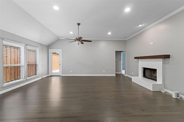 unfurnished living room with ceiling fan, a brick fireplace, ornamental molding, and dark hardwood / wood-style floors