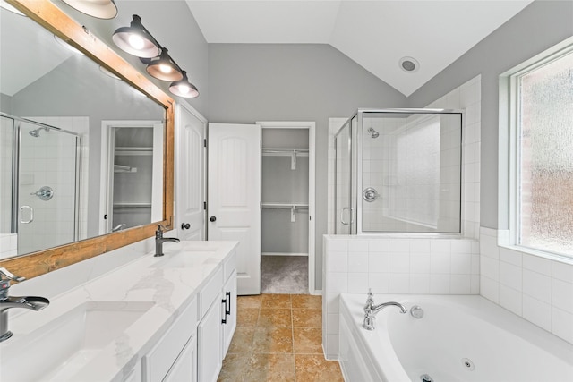 bathroom with vanity, lofted ceiling, and independent shower and bath