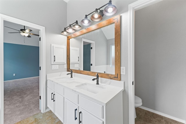 bathroom with ceiling fan, toilet, lofted ceiling, and vanity