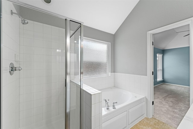 bathroom featuring plenty of natural light, separate shower and tub, tile patterned flooring, and lofted ceiling