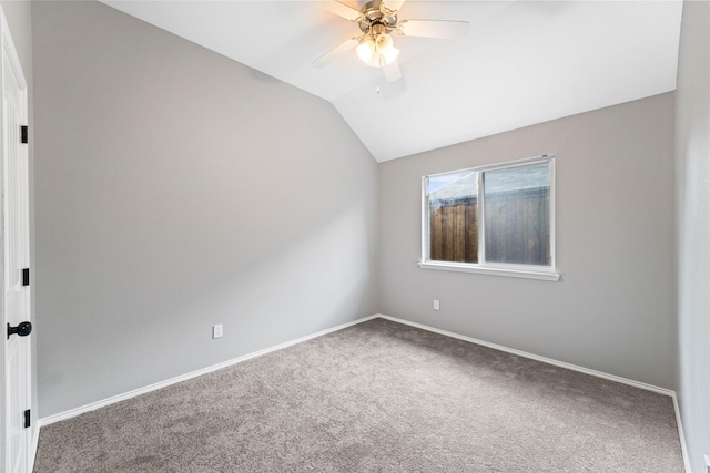 carpeted spare room with ceiling fan and lofted ceiling