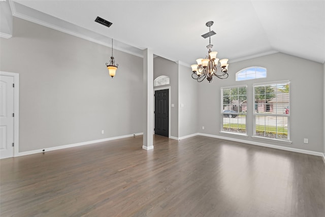 spare room featuring crown molding, dark hardwood / wood-style flooring, lofted ceiling, and an inviting chandelier