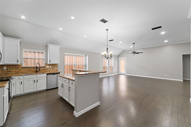 kitchen featuring white cabinetry, a center island, stainless steel appliances, and vaulted ceiling