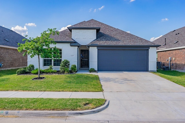 view of front of home featuring a front lawn and a garage