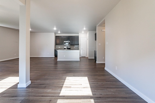 unfurnished living room with dark hardwood / wood-style floors