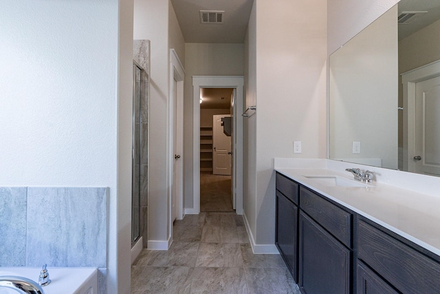 bathroom with vanity and plus walk in shower