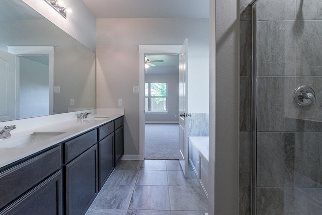 bathroom featuring ceiling fan, vanity, and a tub