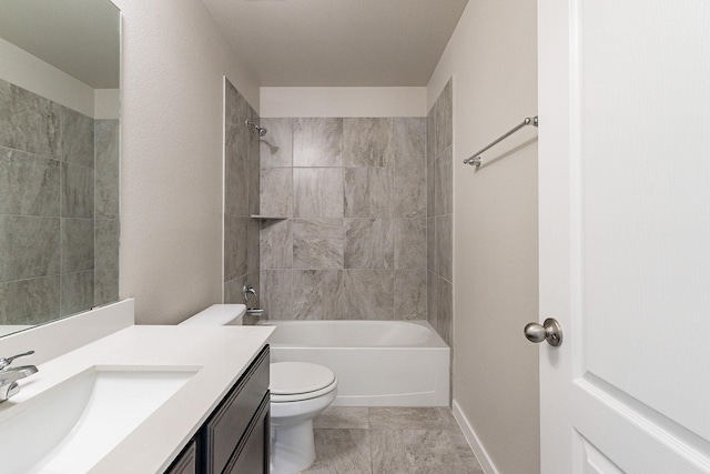 full bathroom with toilet, tiled shower / bath, and vanity