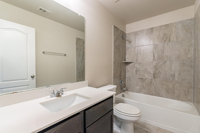 full bathroom with toilet, tiled shower / bath combo, tile patterned floors, and vanity