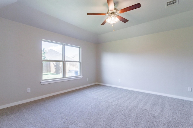 carpeted spare room featuring ceiling fan and lofted ceiling