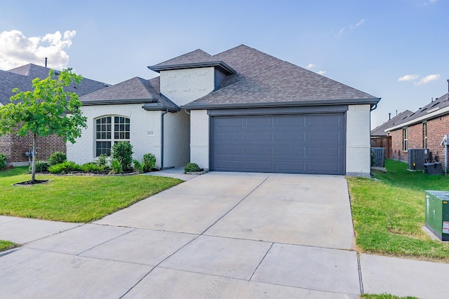 view of front facade featuring a garage, a front yard, and central AC