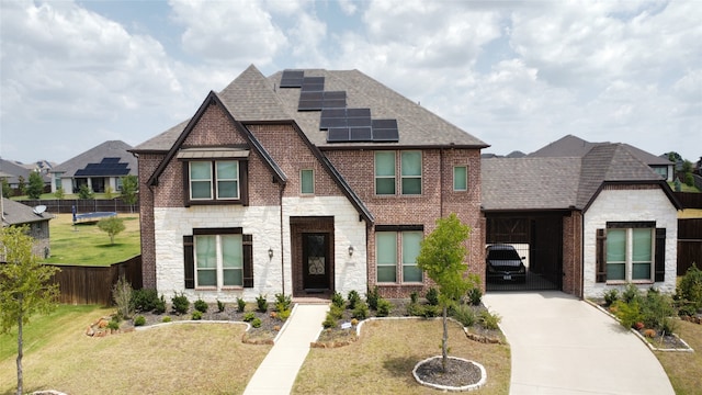 view of front facade with solar panels and a front yard