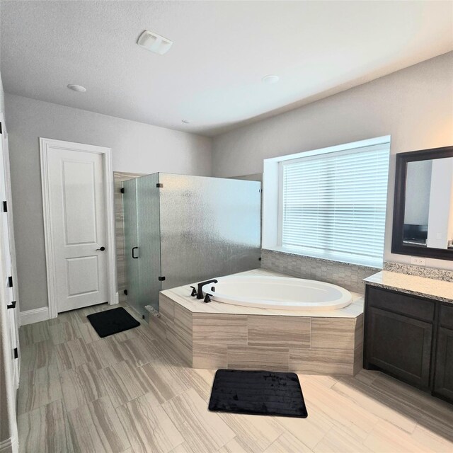 bathroom with vanity, shower with separate bathtub, and tile patterned floors