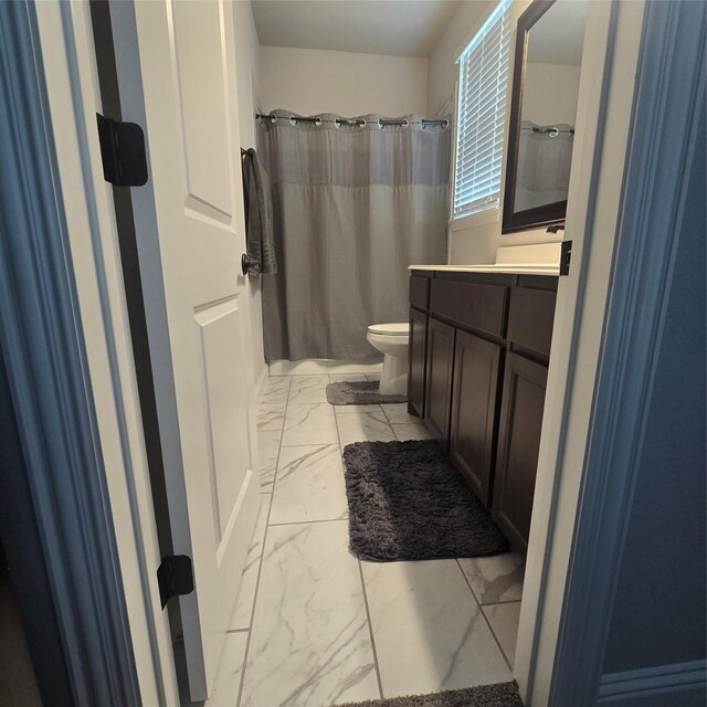 bathroom with vanity, toilet, and tile patterned floors