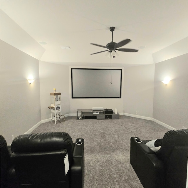 carpeted home theater room with ceiling fan