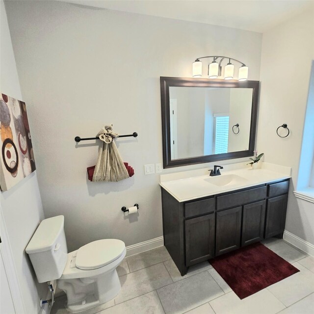 bathroom featuring tile patterned floors, toilet, and vanity