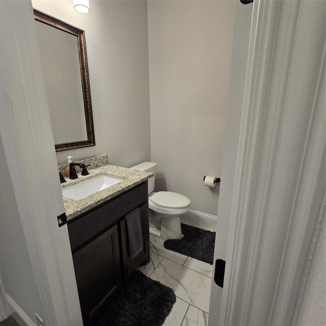 bathroom featuring vanity, toilet, and tile patterned floors