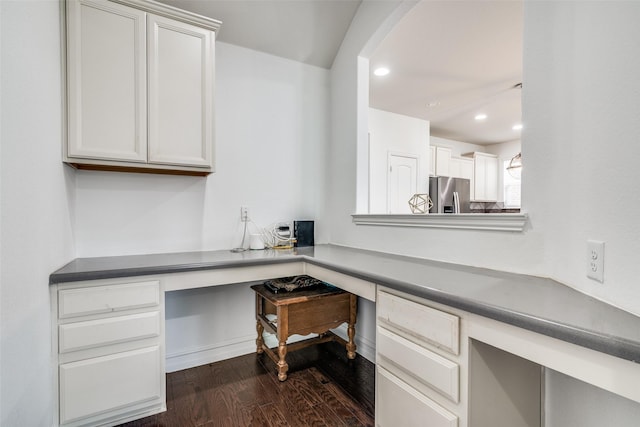 office area with built in desk and dark hardwood / wood-style floors