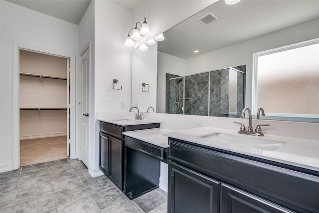 bathroom featuring tile patterned floors, an enclosed shower, and dual bowl vanity