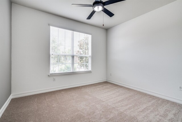 empty room with light colored carpet and ceiling fan