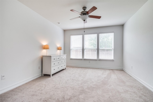 unfurnished bedroom with light colored carpet and ceiling fan