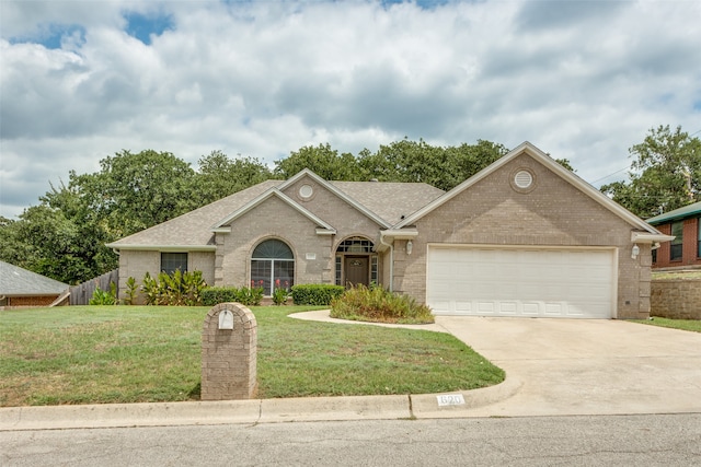 view of front of home featuring a garage and a front lawn