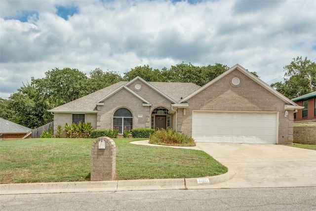 ranch-style home featuring driveway, a garage, fence, a front lawn, and brick siding