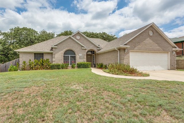 ranch-style home with a garage and a front lawn