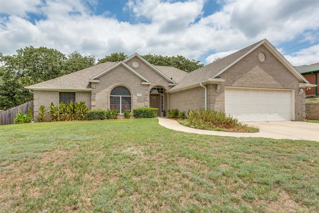 single story home with concrete driveway, brick siding, an attached garage, and a front lawn