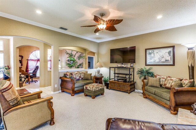 carpeted living room featuring ceiling fan, crown molding, and a textured ceiling