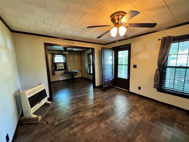 entrance foyer featuring ceiling fan, crown molding, heating unit, and dark hardwood / wood-style floors